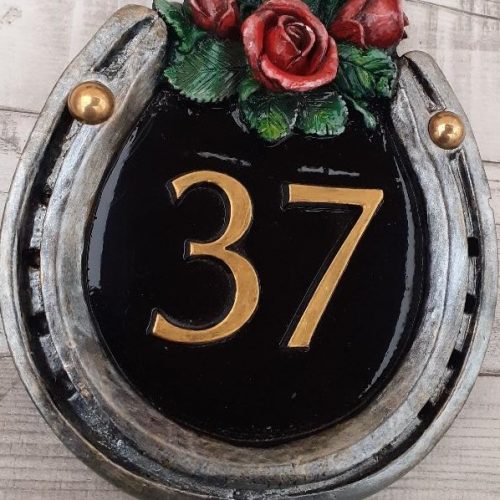 Horseshoe shaped house signs